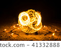 fire twirler dancing with circular light effects 41332888