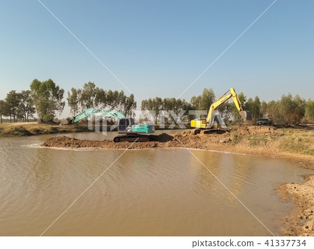 Backhoe is dredging the river 41337734