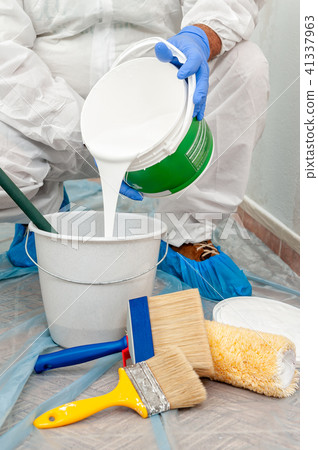 House painter at work prepares white paint 41337963