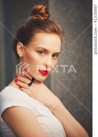 beautiful blonde girl on the street 41338997