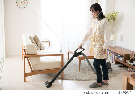 A young Japanese lady wearing a vacuum cleaner 41339894