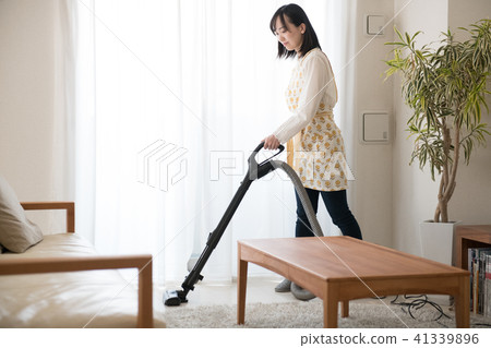 A young Japanese lady wearing a vacuum cleaner 41339896