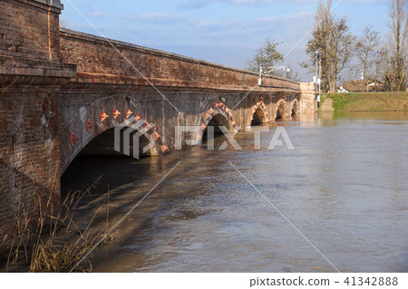 bridge with full river . River is full . Bridge to cross the river that is flooding. bridge with full river . River is full . Bridge to cross the river that is flooding. 41342888