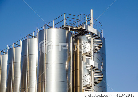 Silver wine Silos with blue sky in background Silver wine Silos with blue sky in background 41342913