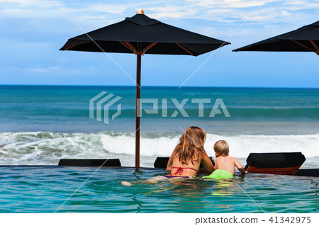 Mother with son chilling in beach swimming pool 41342975