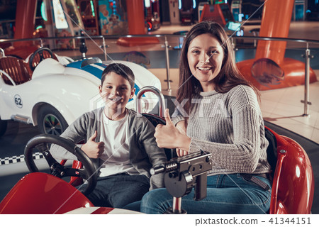 Happy smiling mother and son in toy car 41344151