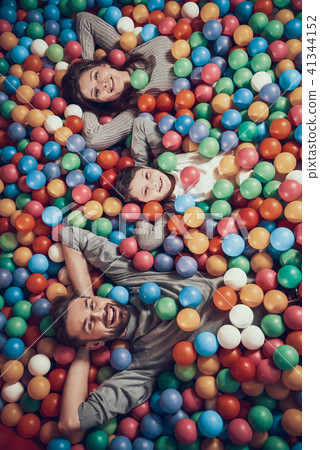 Top view. Happy family lying in pool with balls Top view. Happy family lying in pool with balls 41344152