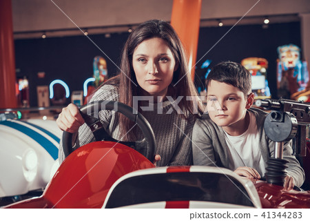 Concentrated mother and son driving toy car 41344283