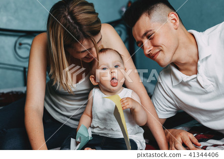 Parents playing educational game with daughter 41344406