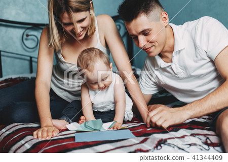 Parents playing educational game with daughter 41344409