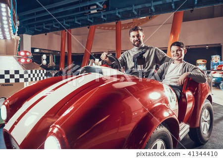 Joyfull father and son in amusement center 41344410