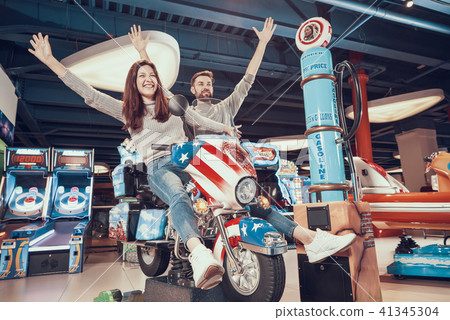 Happy dad and mom in amusement park Happy dad and mom in amusement park 41345304
