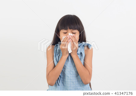 sick little girl blowing her nose isolated on whit sick little girl blowing her nose isolated on whit 41347176