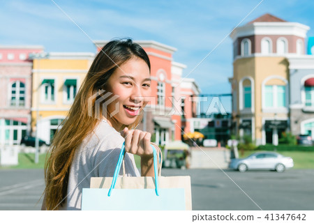 Asian woman shopping an outdoor flea market. 41347642