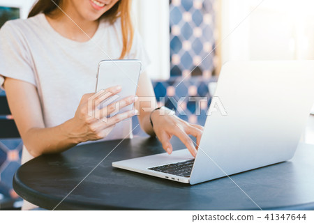 Asian woman drink coffee and use smartphone. 41347644