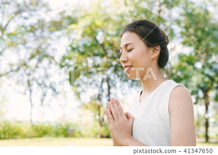 asian woman yoga outdoors while practice yoga. asian woman yoga outdoors while practice yoga. 41347650