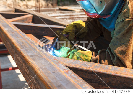 Worker welding in a factory. Welding on an industrial plant. Worker welding in a factory. Welding on an industrial plant. 41347789