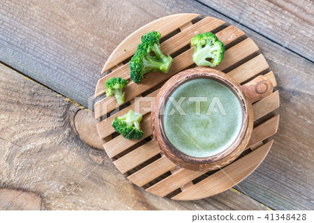 Cup of broccoli coffee with broccoli florets Cup of broccoli coffee with broccoli florets 41348428