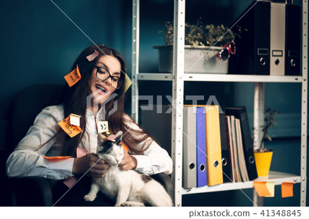 Woman with stickers all over her holding cat. 41348845