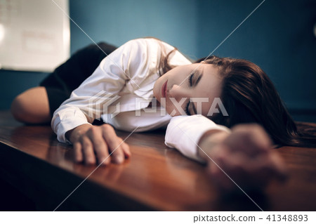 Lady lying on chair in unusual position reading book. Lady lying on chair in unusual position reading book. 41348893