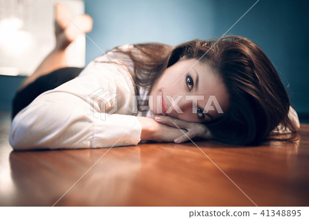 Business woman lying on table. Business woman lying on table. 41348895