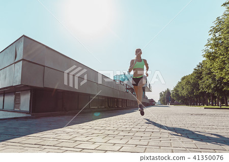 Pretty sporty woman jogging at city Pretty sporty woman jogging at city 41350076