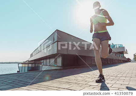 Pretty sporty woman jogging at city Pretty sporty woman jogging at city 41350079