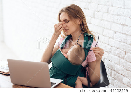 Tired business woman with baby try to work. 41352329