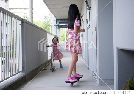 Children sister playing scooter and lipstick 41354105