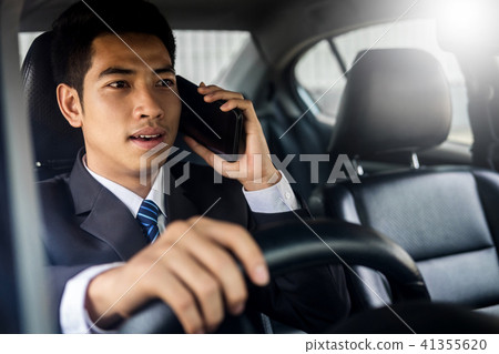Attractive handsome young businessman using mobile smart phone i 41355620