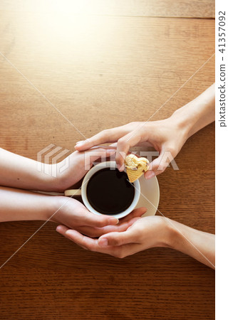 Coffee cup and hands of man and woman 41357092