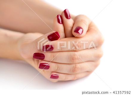 Closeup of hands of young woman with red manicure 41357592