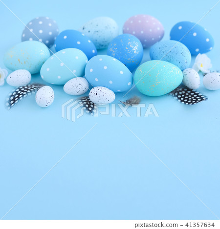 Easter eggs on blue background with empty space Easter eggs on blue background with empty space 41357634