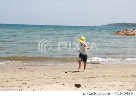A boy running away from the waves 41360429
