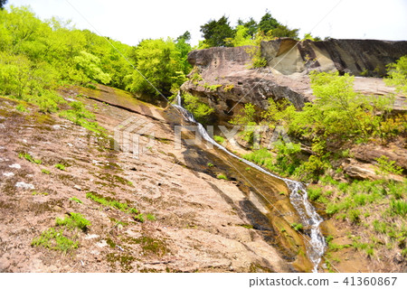 A small waterfall that runs down the rock face A small waterfall that runs down the rock face 41360867