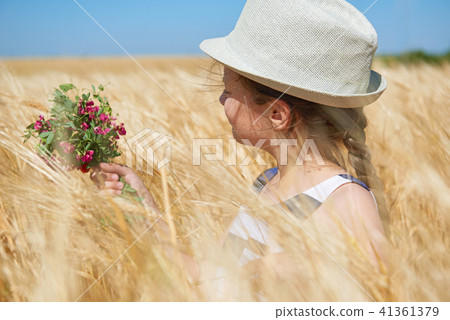 child girl walking in the yellow wheat field child girl walking in the yellow wheat field 41361379