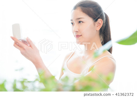 Woman sitting in the living room Woman sitting in the living room 41362372