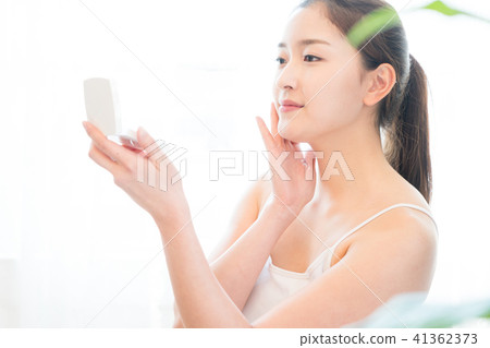 Woman sitting in the living room Woman sitting in the living room 41362373