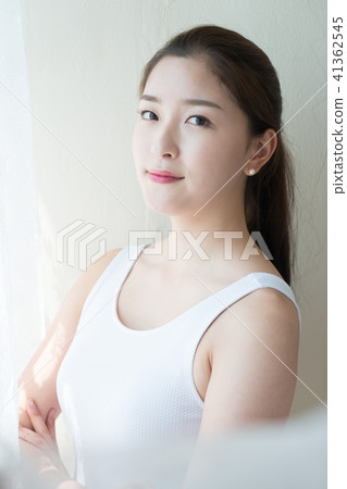 A woman sitting at a window 41362545
