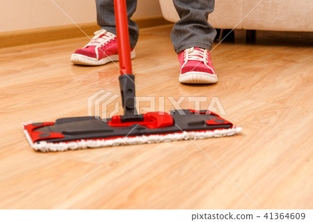 Photo of man's feet with mop washer floor 41364609