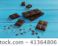 Chocolate pieces on blue wooden background 41364806