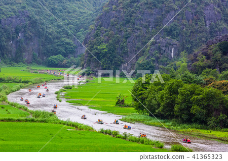 Tourists traveling in boat, tamcoc, ninhbinh Tourists traveling in boat, tamcoc, ninhbinh 41365323