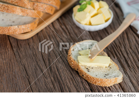 Sliced of Sesame bread with butter on wood board. Sliced of Sesame bread with butter on wood board. 41365860