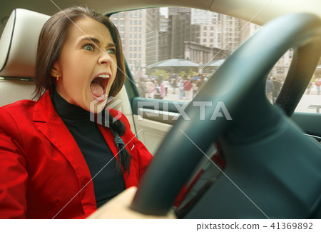 Driving around city. Young attractive woman driving a car 41369892