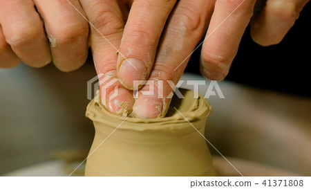 Professional potter shaping mug in pottery workshop Professional potter shaping mug in pottery workshop 41371808
