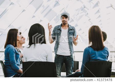 Young bearded man shares problems with other Young bearded man shares problems with other 41373478