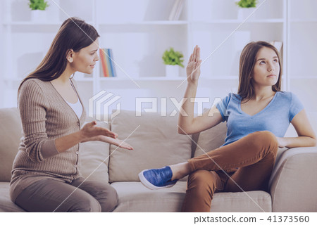 Teen girl showing stop gesture to angry mother 41373560