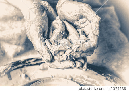 knead, raminanie clay in the hands of man. Old vintage style. knead, raminanie clay in the hands of man. Old vintage style. 41374388