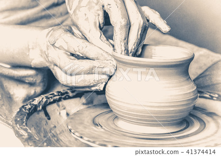 potter making vase from clay. Old vintage style. potter making vase from clay. Old vintage style. 41374414
