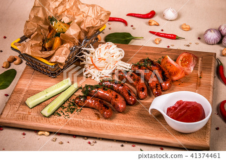 Grilled sausages with cucumber and ketchup 41374461